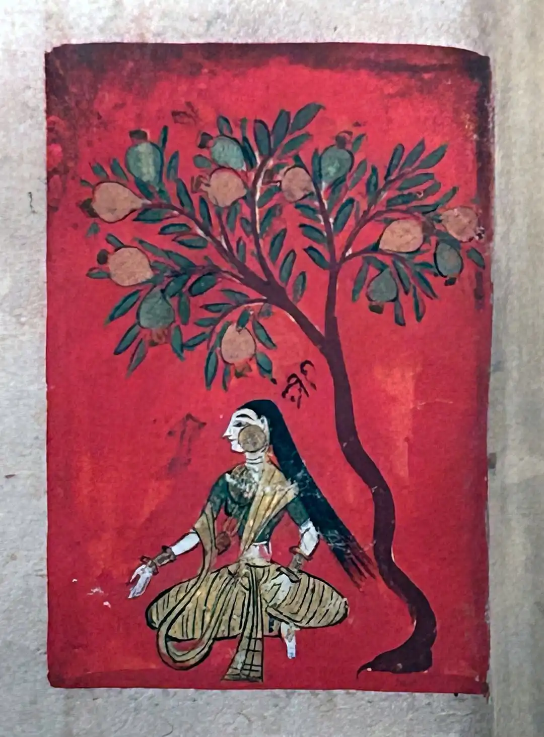 A stylised picture of Eve; a maiden seated beneath a pomegranate tree