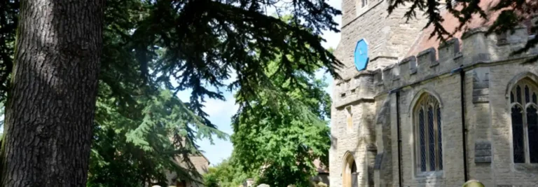 St James's Church clock tower through the trees